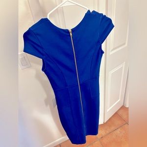 Business-like royal blue dress with gold zipper. New. Stretchy & form-fitting.